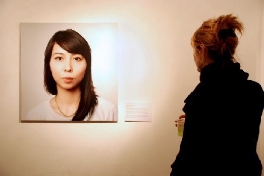 A woman looking at a photo of a half Japanese woman