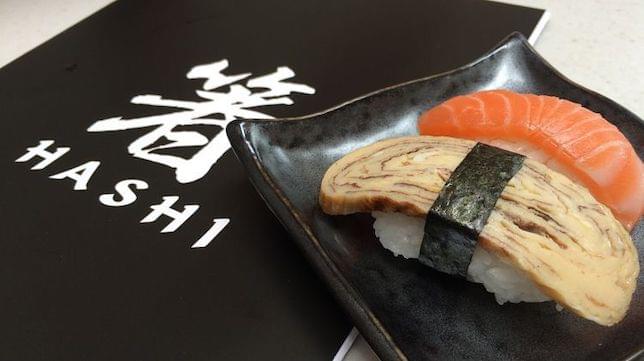 Some sushi on a decorative plate