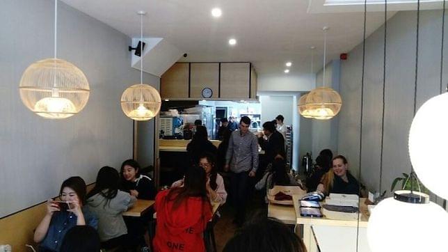 Customers sitting and ordering food in a Japanese restaurant