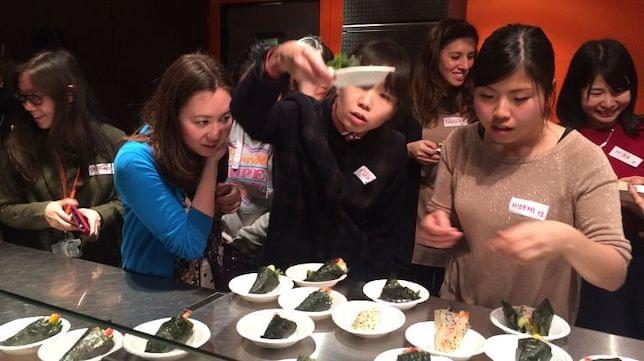 A group of women tasting various Japanese food items