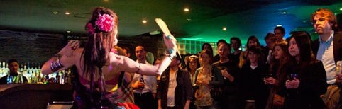 A woman dancing Fusion dance in front of a small crowd