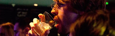 A man drinking CHOYA Umeshu from a glass