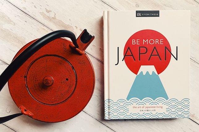 A Japanese lifestyle book and a teapot on a table