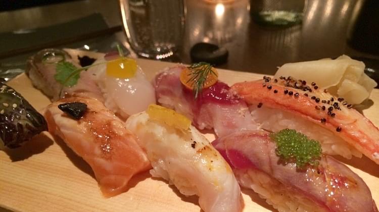 Some sushi on a wooden board