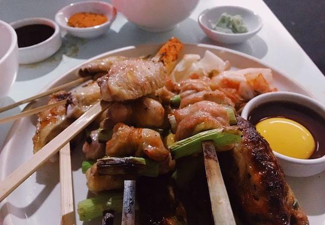 Yakitori skewers prepared on a plate in a restaurant