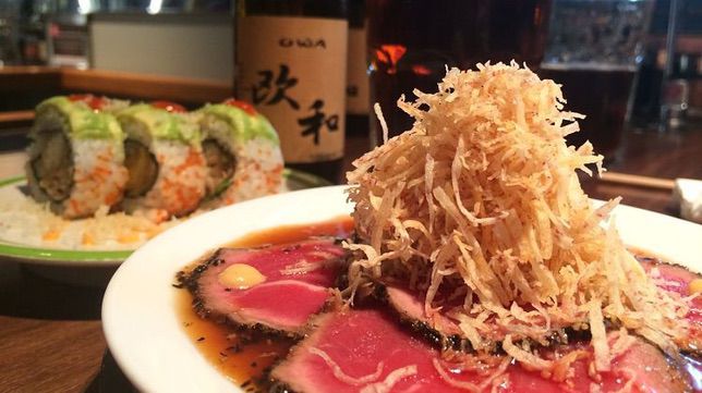 Some Japanese food and beer on a table