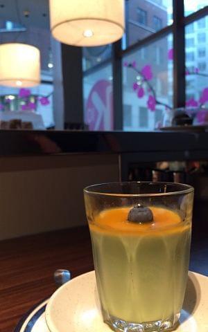 A green tea mousse dessert on a table in a restaurant