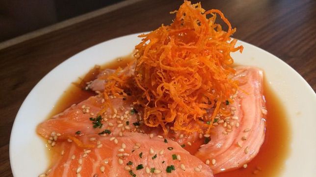 A Japanese style salmon and carrot dish on a plate