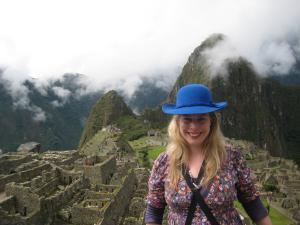 A woman standing with a view of Machu Picchu in the background