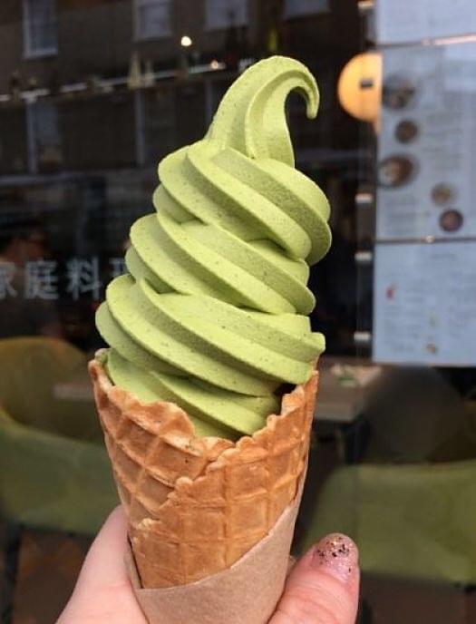 Vanessa holding a Matcha ice-cream outside a cafe