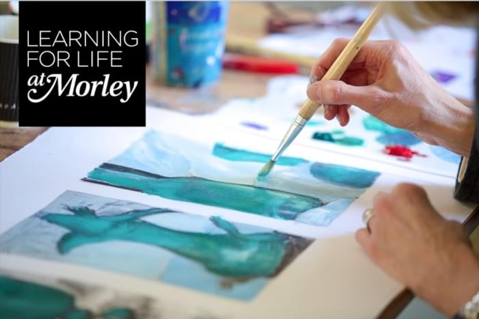 A woman with a paintbrush painting Japanese art