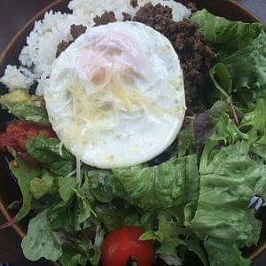 Some rice in a bowl with some salad