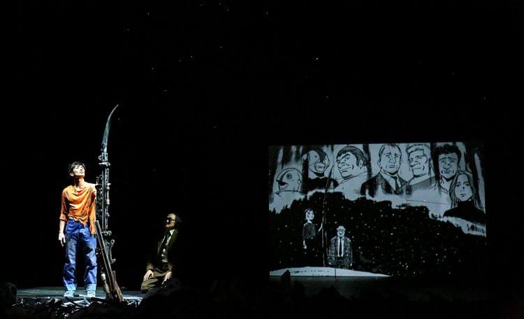 Two men performing on a stage at the Barbican