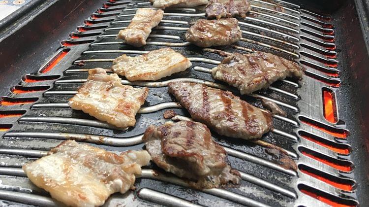 Some BBQ meat cooking on a hot grill