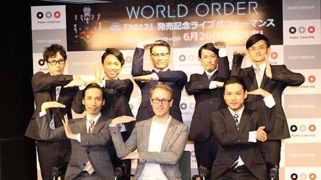 Tom Smith with members of World Order making hand gestures